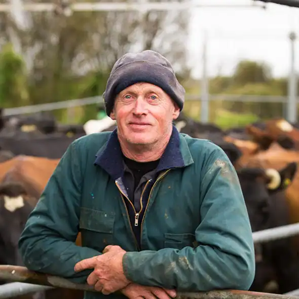 Ian Maxwell, West Coast dairy farmer, leaning on a cattle rail