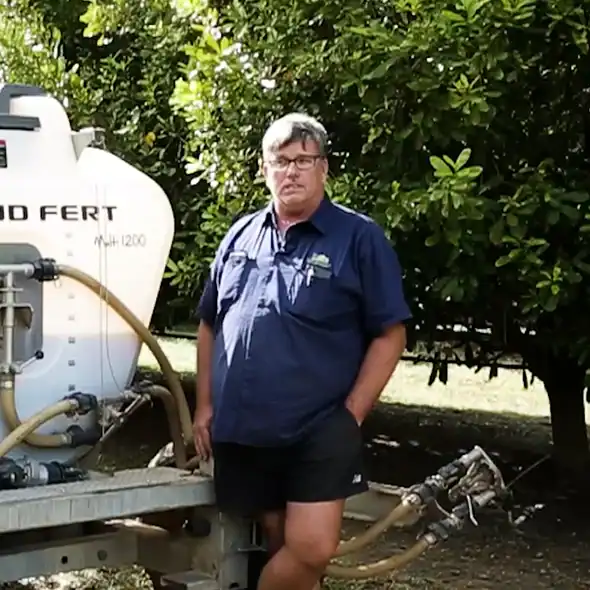 Dave Shackson, farm manager, stands with his Tow and Fert Multi 1200 in the Macadamia Orchard he manages.