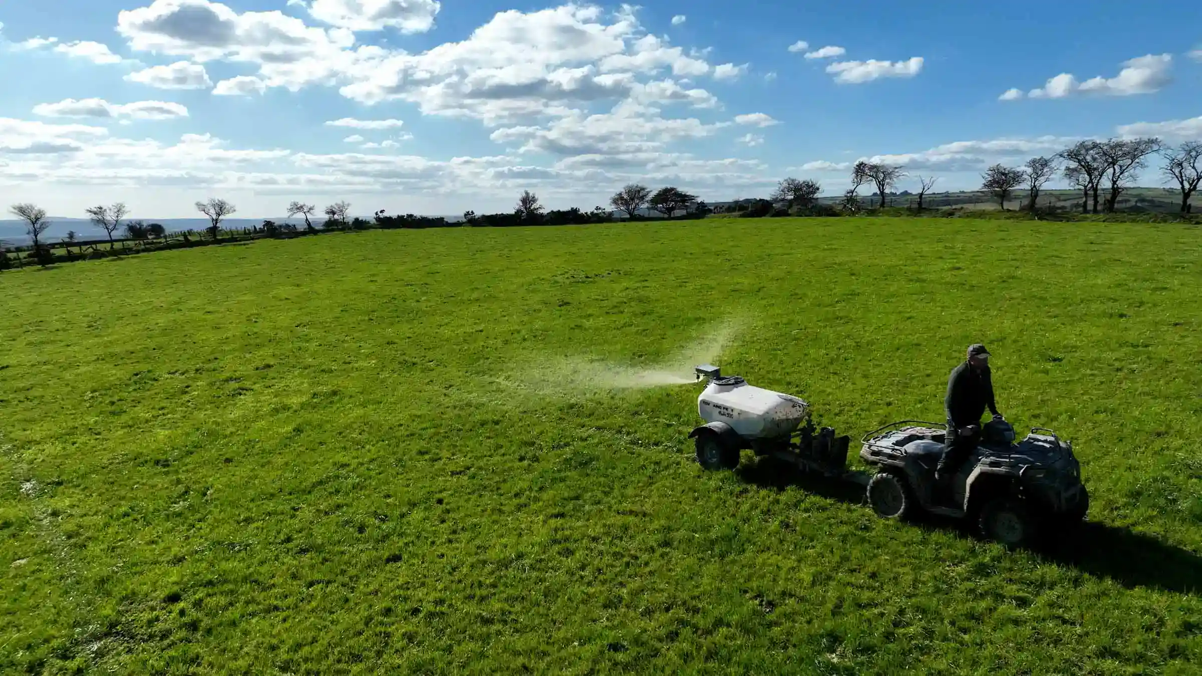 Drone image of a Tow and Fert Multi 500 being towed by a Quad bike on farm in Wales