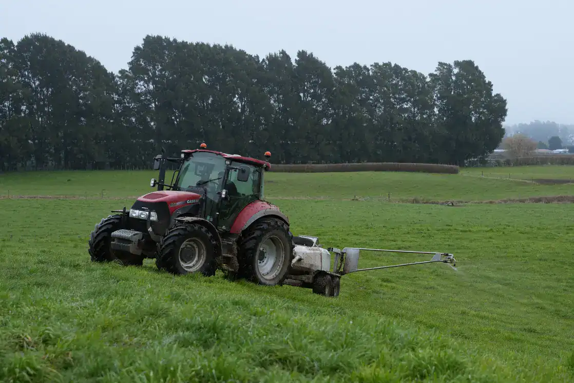 A tractor pulling a Tow and Fert Multi 1000 on a Dairy Farm in Cambridge, Waikato